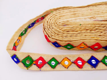 Wholesale Beige Cotton Fabric Mirrored Trim With Embroidery In Yellow, Blue, Red & Green Threads
